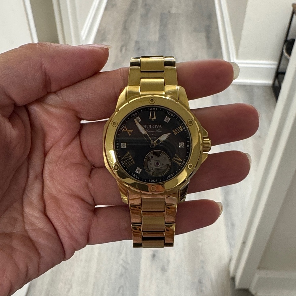 Bulova Gold Timepiece with Black Face